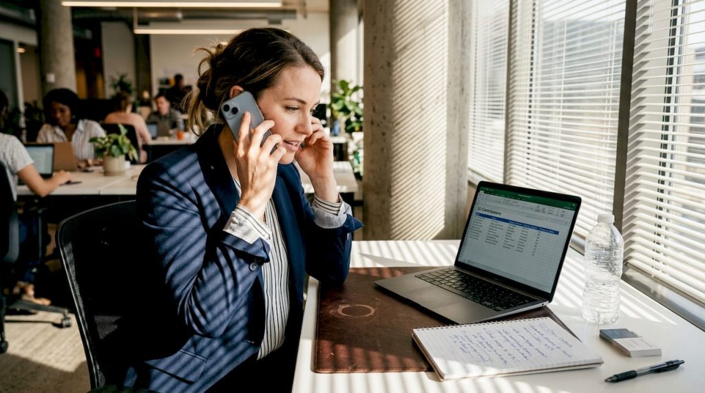 Real estate agent making follow-up calls in office