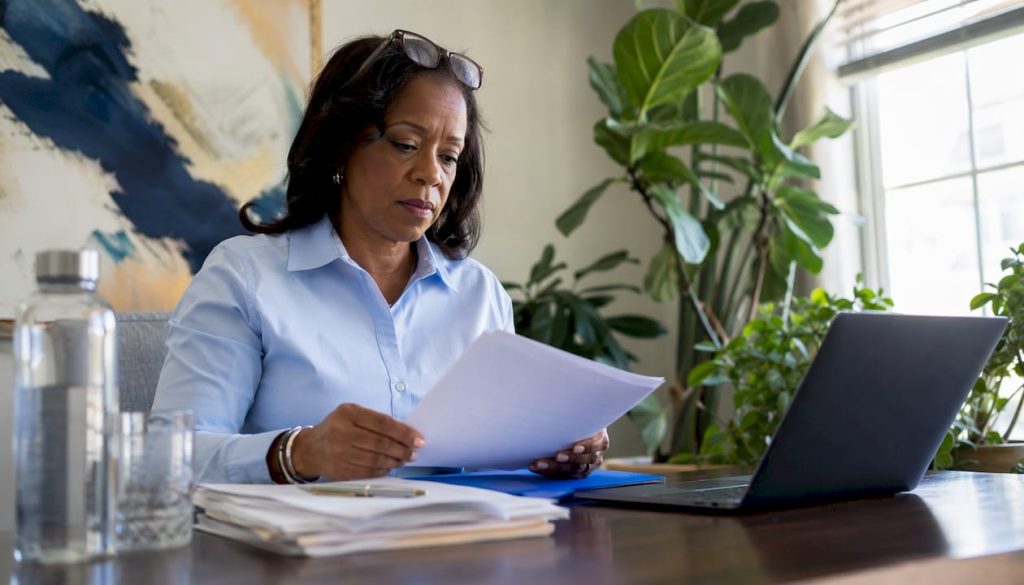 Real estate agent reviewing closing call documents at desk
